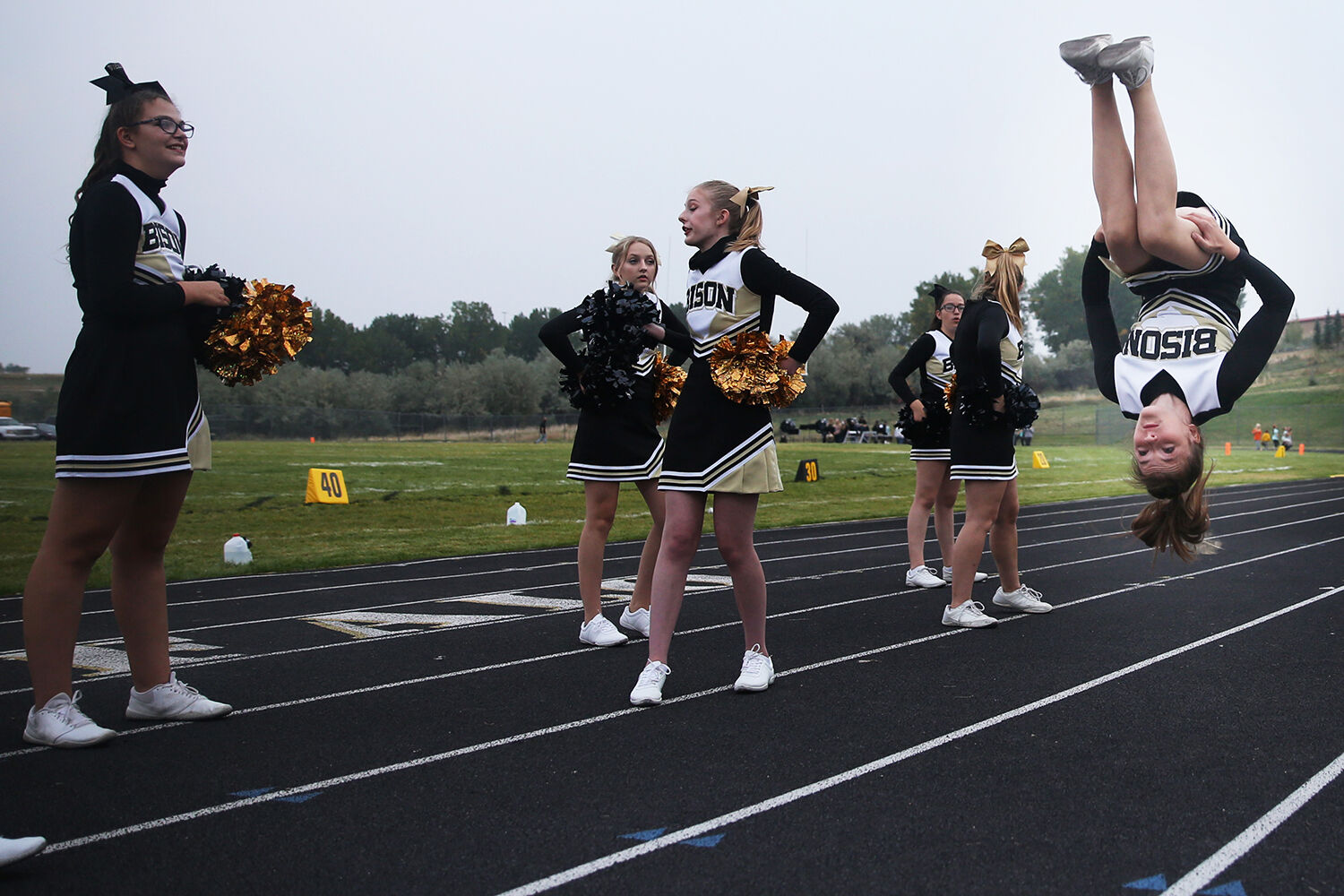 Kyla Wright hangs upside down in the air as she completes a flip